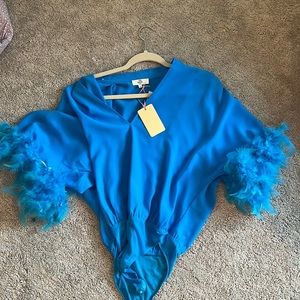 NWT bright blue body suit with feathers